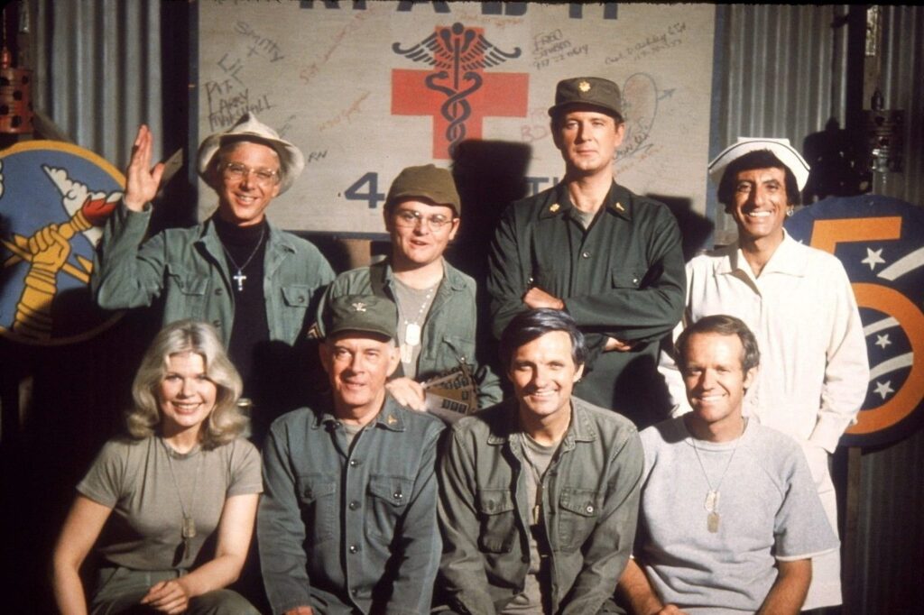 cast with Loretta Swit, in army uniforms, capturing the show’s iconic legacy.