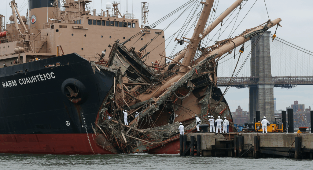 ARM Cuauhtémoc at Pier 36 with broken masts, showing the aftermath of the Brooklyn Bridge crash.